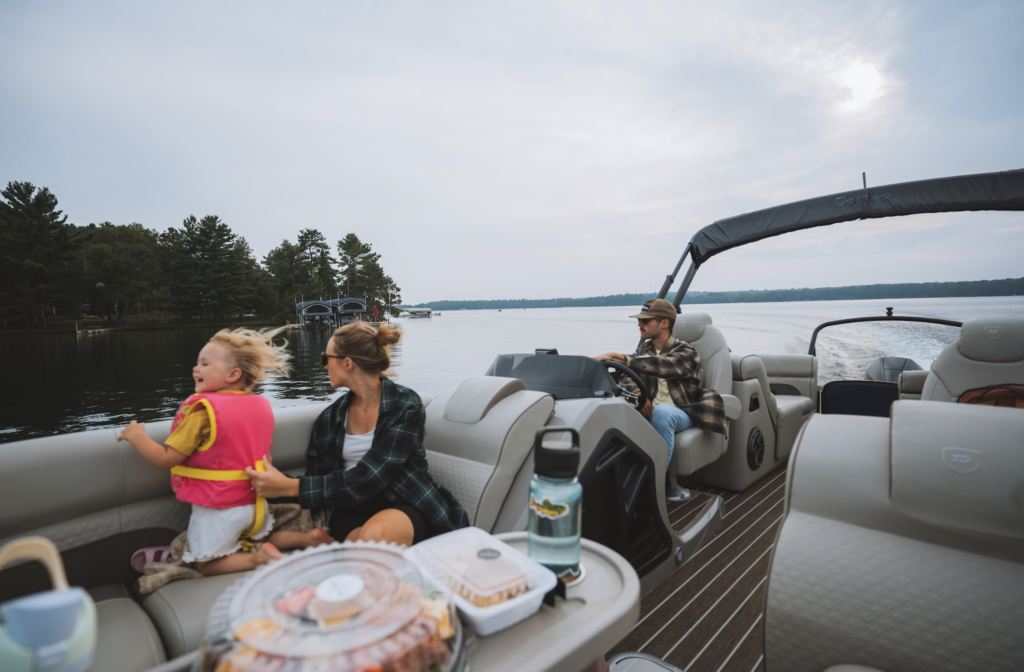 Young family in a pontoon on the lake in Minnesota